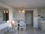 The dining room, the entrance and the kitchen area.