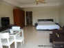 View of the studio, the entrance and the kitchen in the background
