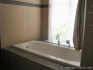 The bathtub in the bathroom.